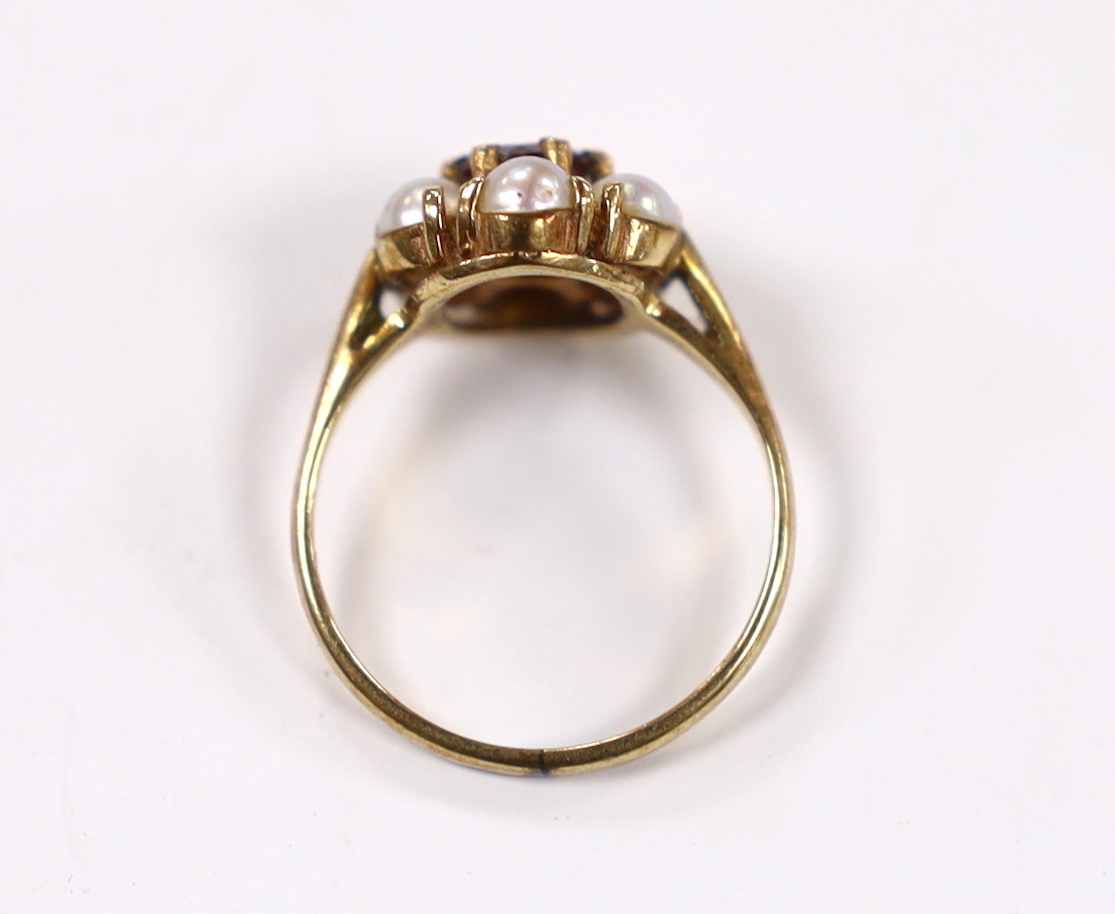 A 9ct gold, garnet and seed pearl cluster set flower head ring, size I, gross weight 2.4 grams.